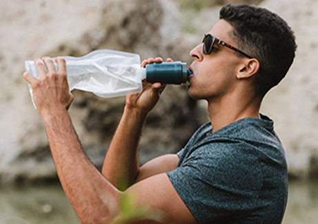 wellness water company - a man with water testing machine