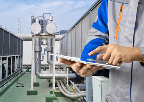 wellness water company - a man holding a tablet on top of a building