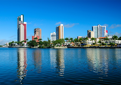 wellness water company - a body of water with a city in the background