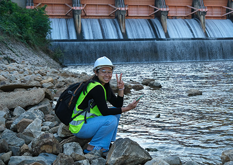 wellness water company - a person wearing a hard hat and holding a phone near water plant