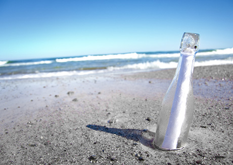 welness water company - a glass bottle with a message in it on the beach